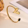 Gold-plated stainless steel open cuff bracelet featuring asymmetric heart design and black gem. - Black Rhinestone Solid Heart Style (B2284G-2)