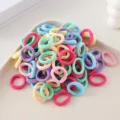 Detailed close-up view of colorful seamless hair ties, high elasticity and soft material. - 100 Pieces/Pack / Mixed Colors I