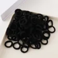 Close-up detail of black seamless hair ties for kids, showing elastic rubber bands in stack. - 100 Pieces/Pack / Mixed Colors J