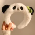 Cute plush panda headband with fluffy white material, black ears and green bamboo bow. - Panda