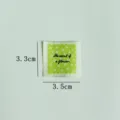Handmade fabric label detail shot, green floral embroidered cloth patch for DIY sewing crafts. - Small Flower (Green Background)