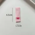 Detail view of pink woven label with heart embroidery and fresh text for DIY crafts. - Pink Grid Heart Style (zm110) / 4.5x1.5cm
