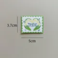 Detail view of embroidered lily of the valley woven patch, 3.7x5cm stamp design for DIY craft. - Lily of the Valley