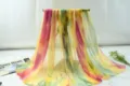 Detailed view of the colorful gradient chiffon scarf, lightweight summer shawl and beach wrap. - Red Yellow Green Gray
