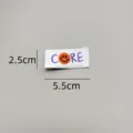 Detail view of the woven smiley face clothing label, showing embroidery and exact dimensions. - zm004