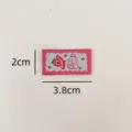 Close-up detail of cute rabbit strawberry woven label, perfect for DIY crafts and clothing. - Strawberry Bunny