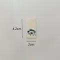 Handmade folded fabric label with cute bear design, perfect for hats, scarves, and clothing. - Bear Label #04