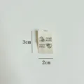 Handmade cloth label with cute cat design, perfect for DIY sewing and apparel accessories. - Cat and Yarn