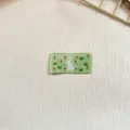 Green woven label patch featuring cute white rabbit and floral design for handmade garments crafts. - Rabbit