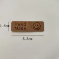 Brown leather handmade label tag with smiley face and size 5.5x1.8cm for DIY crafts. - Smiley Face Dark Brown / L