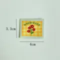 Handmade fabric label with cute floral embroidery, perfect for DIY clothing, bags, and doll accessories. - Small Daisy (Yellow Background)