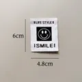 Close-up detail of a black and white smiley face clothing label patch sized 6x4.8cm for DIY. - Black and White Smiley Woven Patch (zm233) / 6x4.8cm