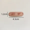 Handmade pink leather label tags with holes, cute heart yarn pattern for DIY sewing crafts. - Heart Handmade Leather Label / Burgundy
