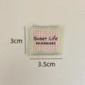 Handmade woven fabric label with green border and pink plaid design for DIY sewing projects. - Sweet Life Style / Pink Grid with Green Border