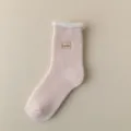 Close-up of pink winter thermal sock with cozy fleece cuff and sweet embroidery detail. - One Size / Light Pink