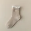 Cozy fleece-lined mid-calf sock detail showing soft plush cuff and cute stitched label. - One Size / Khaki