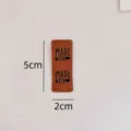 Brown leather handmade labels for DIY sewing crafts, embossed tags with four holes. - Rectangle 01