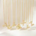 Detailed view of gold-plated micro-paved cubic zirconia puffy letter pendant necklaces. - Necklace D
