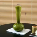 Detailed view of the elegant green glass vase showcasing its unique shape and smooth finish. - S / Ceramic-Look Green