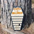 Wooden coffin-shaped Halloween countdown calendar displayed against a tree trunk - Halloween countdown ornament 30*16.5CM