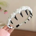 Green and white plaid headband with teeth, detail view showing fabric wrapped hair hoop design. - Green