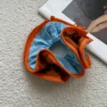 Detail shot of creative color-contrast zipper hair scrunchie, stylish hair accessory. - Zipper Style / Orange Zipper Style