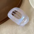 Detail view of pearlescent jelly hair claw clip, showing transparent oval design and spring. - Ellipse / Purple