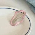 Pink and white plaid wavy hair clip detail shot, sweet style accessory for bangs and styling. - Checkered Cloud Clip