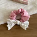 Detail shot of pink scrunchie with white black polka dot bow and pearl, fabric hair accessory. - Pink Bow Hair Tie