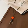Cordón de gafas negro estilo coreano elegante con cuenta naranja y anillo de metal. - Cuentas de Color Naranja