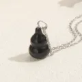 Elegant black gourd pendant necklace with a silver chain for daily wear fashion jewelry. - Black