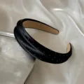 Vue détaillée de l'élégant serre-tête large en satin noir avec de charmants pois blancs. - Noir