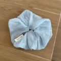 Detail shot of light blue checkered sheer hair scrunchie, soft Korean style hair tie accessory. - Blue