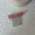 Pink acetate bow hair comb detail view, elegant metal teeth side hair accessory for daily styling. - Pink