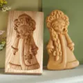 Wooden beechwood cookie mold cutter with a carved girl figure next to shaped dough - 雪姑娘款式 / 13x8x2cm
