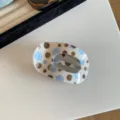 Detailed close-up of a chic blue and brown polka dot acetate hair claw clip for daily wear. - Blue And Coffee Polka Dots