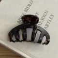 Detailed view of vintage tortoiseshell hair claw clip, large acetate shark clip for thick hair. - Amber