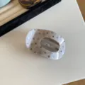 Detailed view of large acetate hair claw clip with stylish dot pattern for women and girls. - Beige Grey Polka Dot