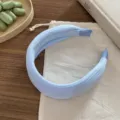 Vue détaillée du serre-tête large en tricot bleu clair, avec une texture côtelée douce et élégante. - Zircon Bleu Clair