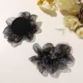 Detail shot of gradient black organza flower hair claw clip, featuring translucent petals and beads. - Yellow & Black