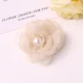Detailed view of elegant mesh camellia flower with faux pearl for DIY hair clips or brooches. - Beige