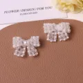 Beaded pearl bow accessory detail shot, sweet DIY material for handmade earrings, hair and shoes. - Clear