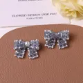 Close-up detail of woven beaded bow jewelry making accessories with pearl and macaron crystals. - Gray