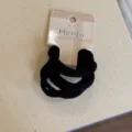 Close-up detail of black elastic hair ties set with packaging card for daily hair styling. - Pack of 6 / Black Series