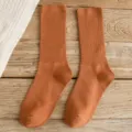 Solid color crew socks in caramel, featuring ribbed knit design for women daily wear style. - One Size / Orange