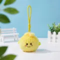 Close-up detail of a cute yellow fluffy plush bun keychain pendant with embroidered face. - Yellow