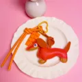 Cute leather dachshund dog bag charm with chocolate pendant and bright orange lanyard key ring. - Orange