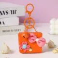 Cute orange woven leather mini bag keychain, stylish bag charm and coin purse gift for women. - Orange