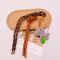 Cute plush horse keychain bag charm with bell and leather strap, perfect accessory. - Brown