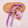 Purple woven lanyard bag charm with plush doll pendant and cute bell, stylish accessory. - Purple